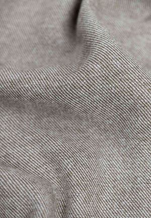 Close up of the fabric of a flannell shirt in brown melange.
