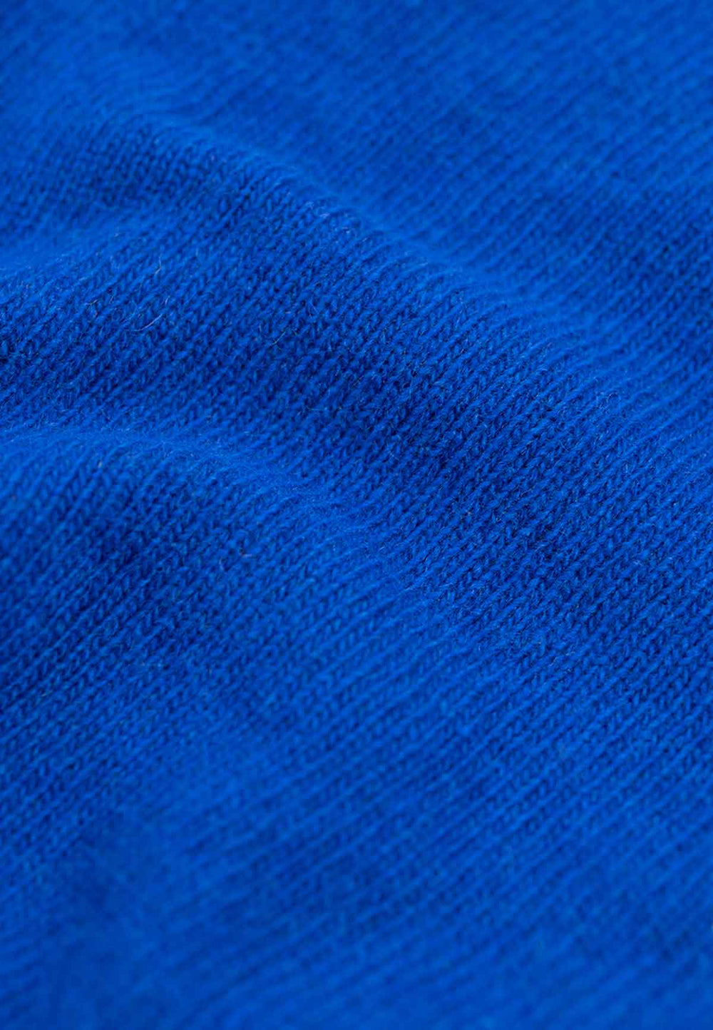 Close up of the knit fabric of a knit hood in cobalt blue.