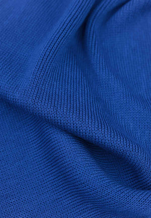 Close up of the knitted fabric of a merino wool scarf in cobalt blue.